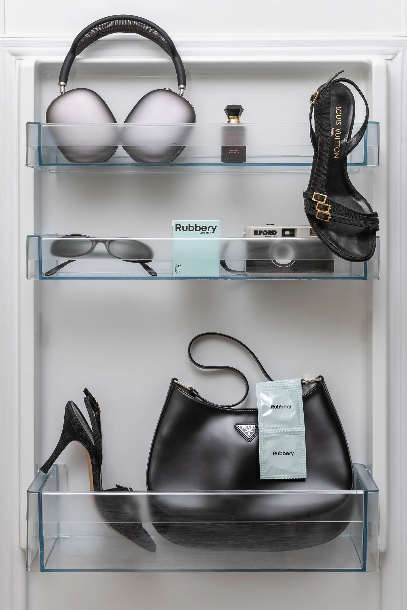 Lifestyle shelf with fashion accessories featuring Rubbery condoms as a modern everyday essential