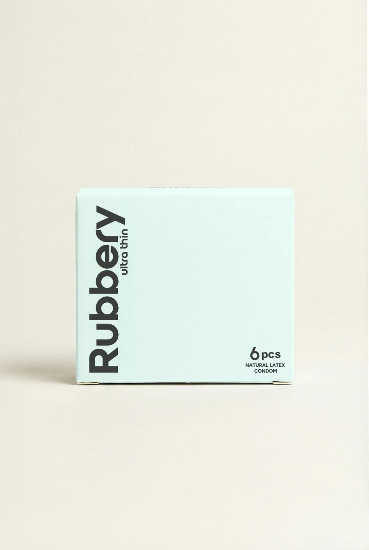 Box of Rubbery condoms on a beige background